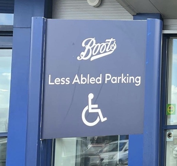 The pharmacy shop brand,Boots Blue parking sign with wheelchair symbol and text reading "Less Abled Parking.